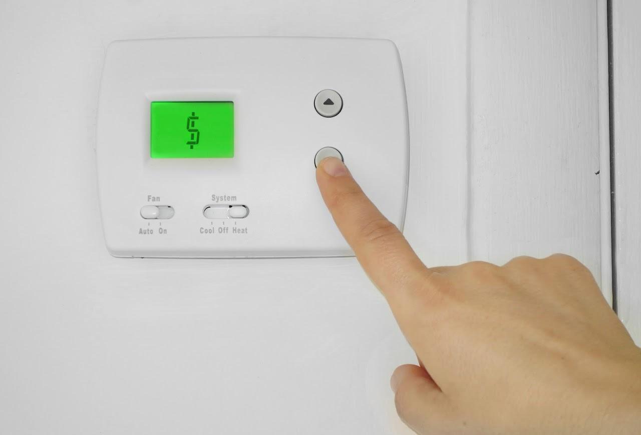 An electronic thermostat fixed on a wall in New Hanover County, NC